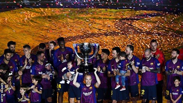 Andres Iniesta lifts the La Liga trophy