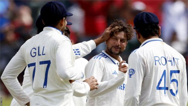 India players congratulate spinner Kuldeep Yadav (middle) on taking a wicket