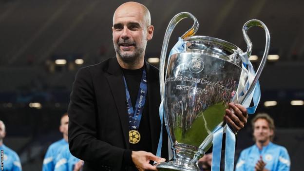 Pep Guardiola manager of Manchester City poses with the trophy at the end of the UEFA Champions League final