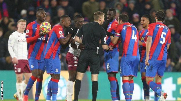Crystal Palace players remonstrating with referee Michael Salisbury