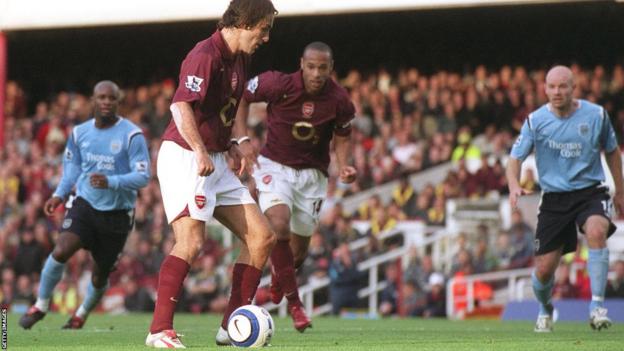 Robert Pires of Arsenal attempts to pass a penalty to team-mate Thierry Henry