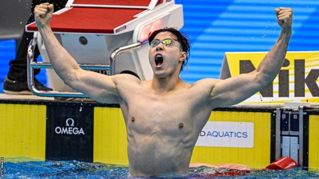 Qin Haiyang celebrates breaking the 200m breaststroke world record