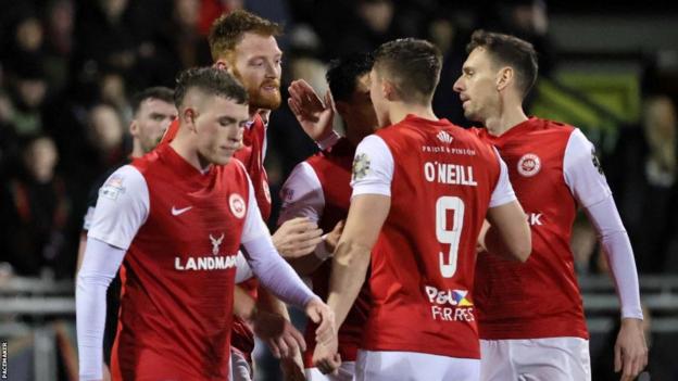 Larne players celebrate Cian Bolger's opening goal
