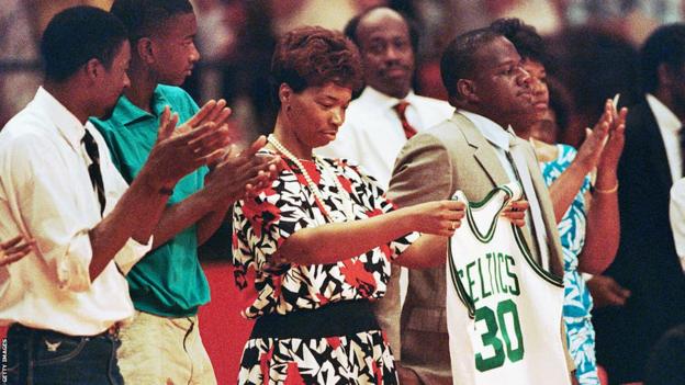 Len Bias' mother Lonise holds a Boston Celtics uniform her son never got to wear during a memorial service at the University of Maryland
