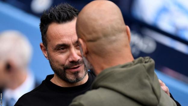 Brighton boss Roberto de Zerbi talks to Manchester City counterpart Pep Guardiola after a match