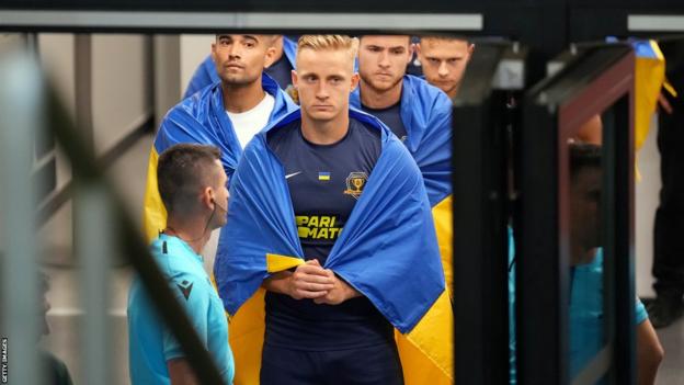 Dnipro captain Oleksandr Svatok waits in a tunnel before the match