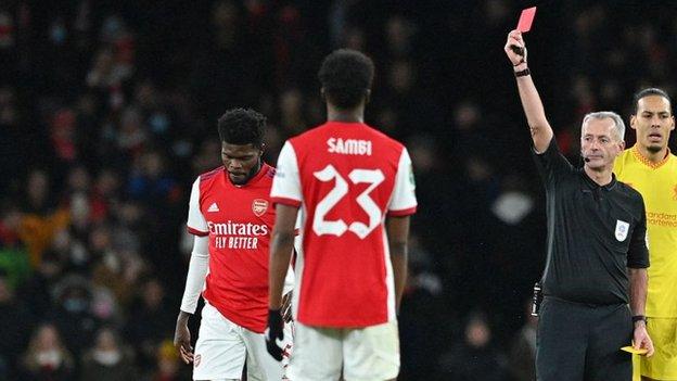 Arsenal's Thomas Partey is shown a red card