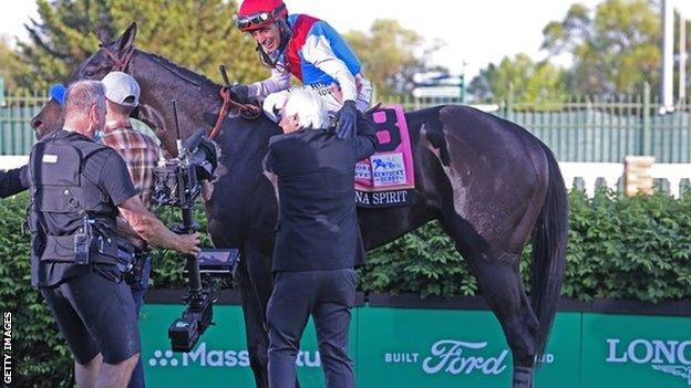 Trainer Bob Baffert congratulates jockey John Velazquez after Medina Spirit wins the Kentucky Derby