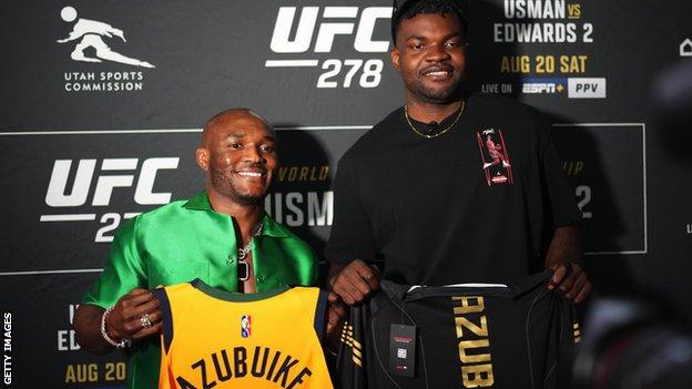 Kamaru Usman of Nigeria and NBA player Udoka Azubuike interact backstage during the UFC 278 press conference at Vivint Arena in August