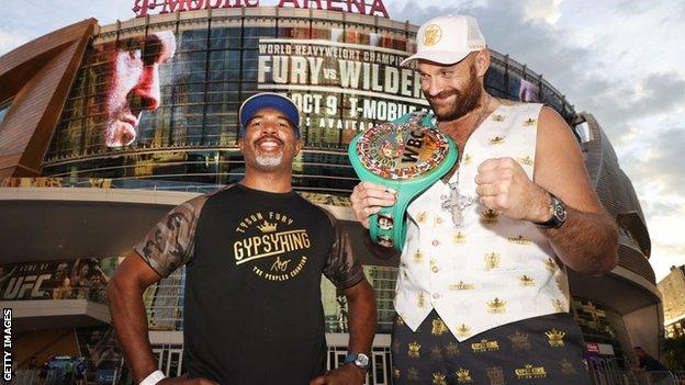 Tyson Fury grins beside his trainer Sugarhill Steward