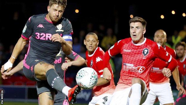 Gaetano Berardi (left) turns home the second Leeds goal