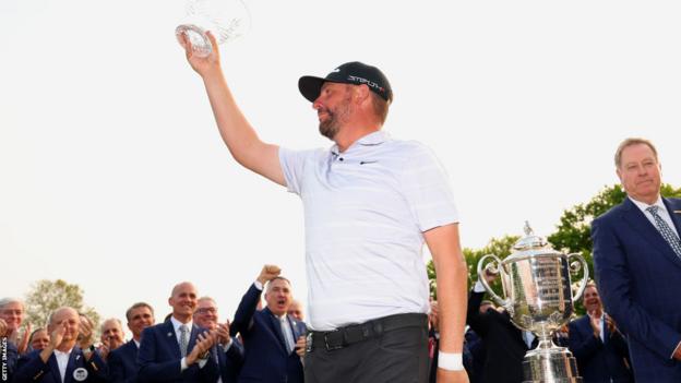 Michael Block holds aloft his trophy as the highest finishing club pro