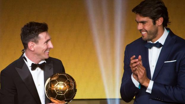 Lionel Messi receives the award from former winner Kaka
