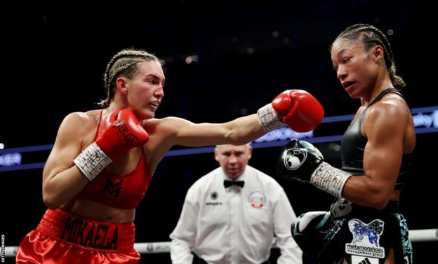 Mikaela Mayer aims a punch at Alycia Baumgardner