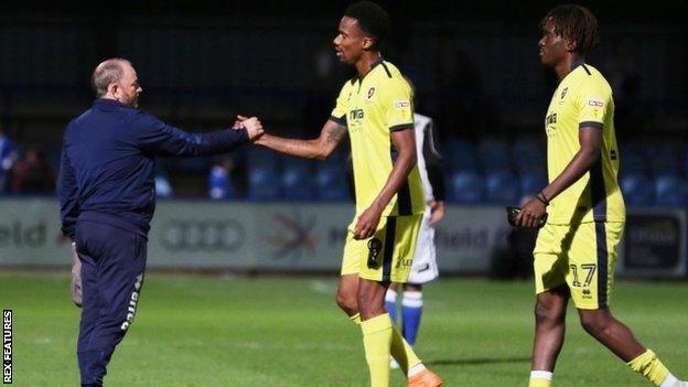 Gary Johnson congratulates goal scorer Manny Duku at the final whistle after taking charge for what proved to be his final game against Macclesfield at Moss Rose