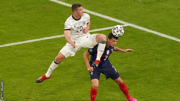 Benjamin Pavard collides with Germany's Robin Gosens