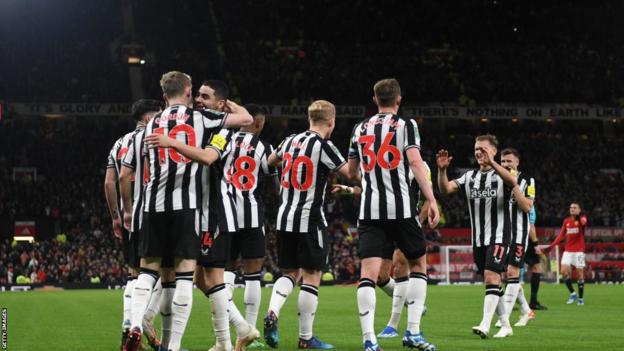 Newcastle players celebrate scoring against Manchester United