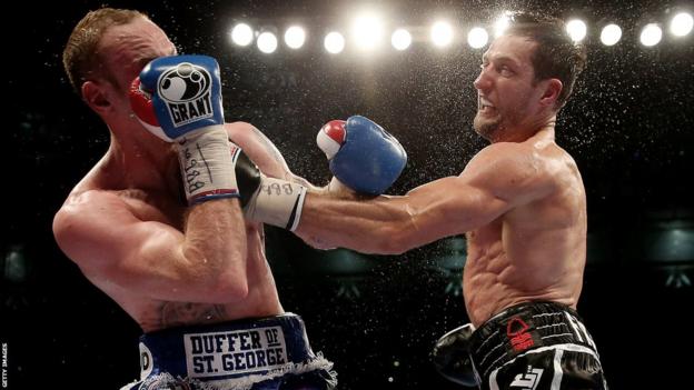 Carl Froch (right) hits George Groves with a punch in their world title fight at Wembley in 2014