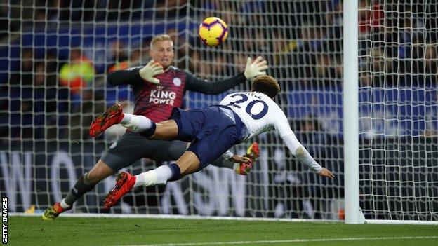 Tottenham midfielder Dele Alli scores with a diving header against Leicester
