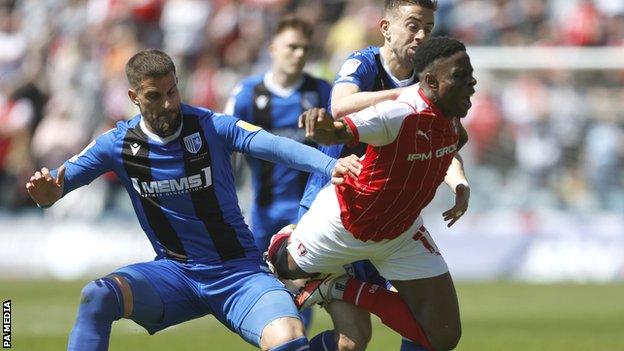 Rotherham United's Chiedozie Ogbene (centre) battle for the ball with Gillingham's Olly Lee