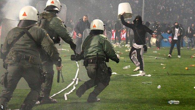 Riot police clash with PAOK fans during their Greek Cup semi-final against Olympiakos