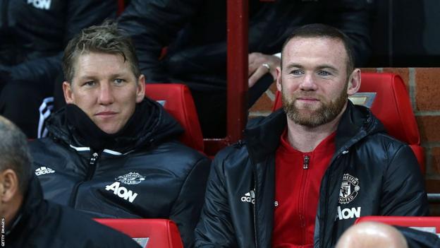 Bastian Schweinsteiger on the bench with Wayne Rooney