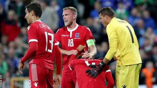 Luxembourg players console Kevin Malget after he scored the decisive own goal in the first half