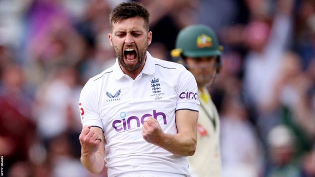 England fast bowler Mark Wood roars in celebration after dismissing Australia captain Pat Cummins