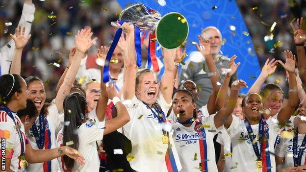 Ada Hegerberg (centre) lifts the Champions League trophy