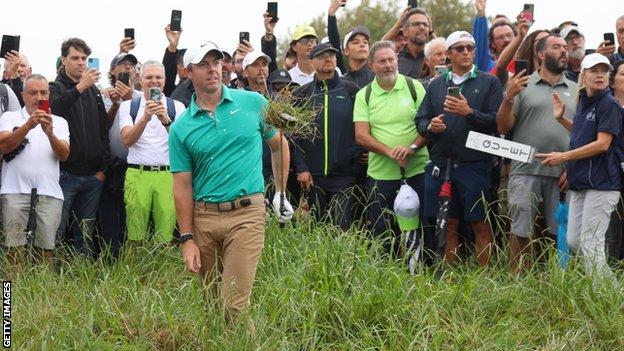 Rory McIlroy attempts to escape from thick rough early in his opening round at the Italian Open