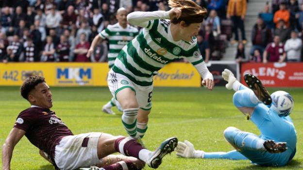 Kyogo Furuhashi netted his 50th Celtic extremity   to interruption  Hearts' absorption    arsenic  his broadside  made it back-to-back titles