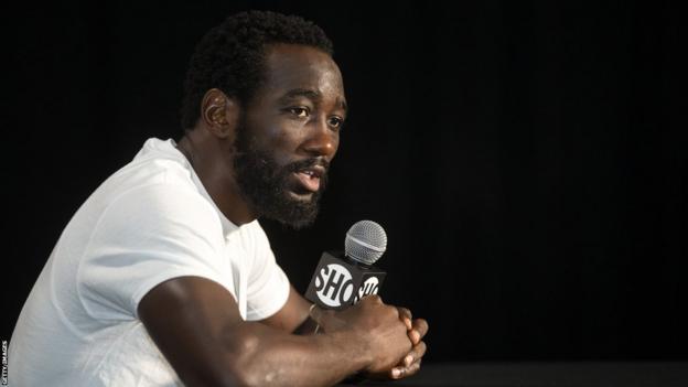 Terence Crawford speaks into a microphone during a news conference