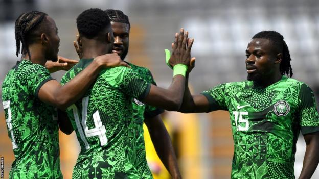 Nigeria players celebrate after scoring a goal during a match against Saudi Arabia