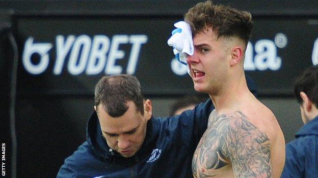 Swansea's Joe Rodon receives treatment to a head injury
