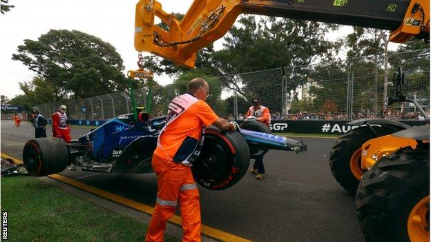 Latifi's damaged Williams is taken away on a crane