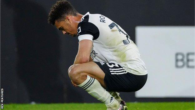 Antonee Robinson kneels down looking dejected after Fulham lose 2-0 against Burnley to be relegated from the Premier League