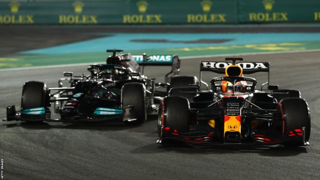 Max Verstappen passes Lewis Hamilton on the final lap of the 2021 Abu Dhabi Grand Prix