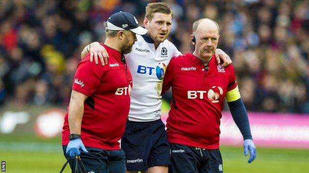 Finn Russell is taken off injured in Scotland's win over France