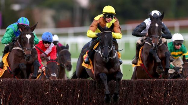 Galopin Des Champs leads at the final fence before moving clear to win the Savills Chase