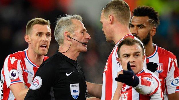 stoke players protest with Martin atkinson