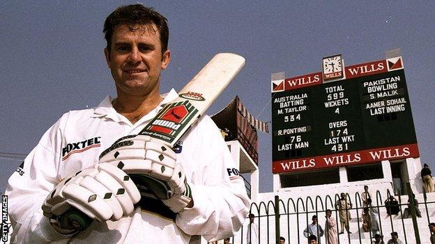 Mark Taylor in front of the scoreboard after he scored 334 not out