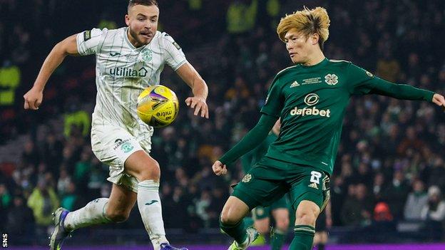 Kyogo lobs the winning goal over Hibs keeper Matt Macey to complete Celtic's cup final comeback