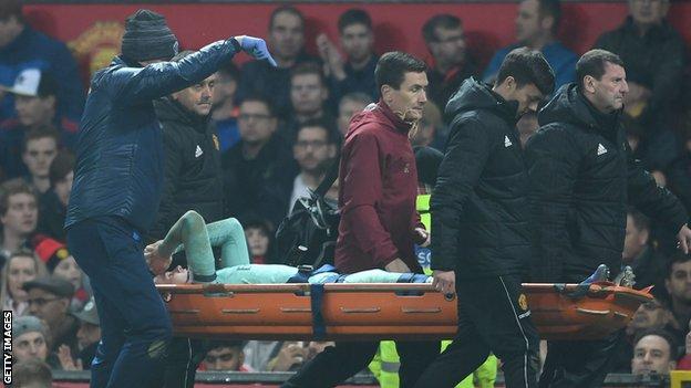 Arsenal's Rob Holding is taken off on a stretcher