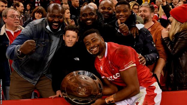 Christ Tshiunza with family after the win against Australia in November 2021