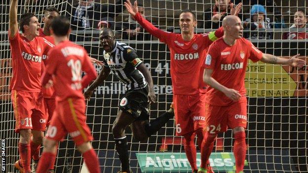 Monaco players protest at a goal from Angers