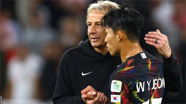South Korea's Son Heung-Min and coach Jurgen Klinsmann look dejected
