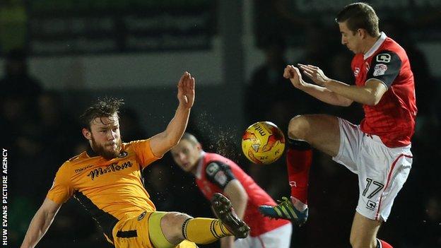 Mark O’Brien of Newport County challenges Andrew Fleming of Morecambe for the ball