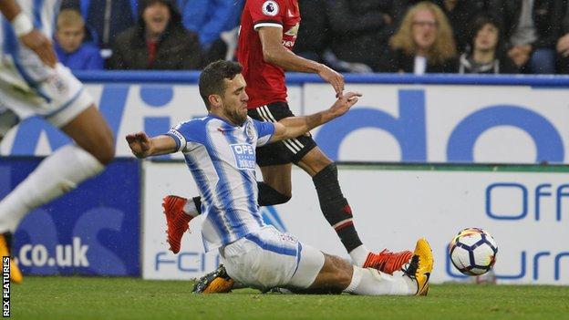 Tommy Smith slides in to tackle Jesse Lingard