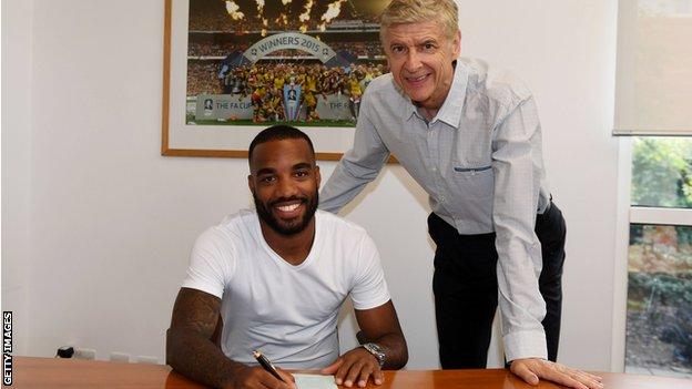 Alexandre Lacazette signs for Arsenal in 2017 watched by Arsene Wenger