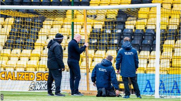 Livingston boss David Martindale fixes a broken crossbar prior to his team's meeting with Ross County